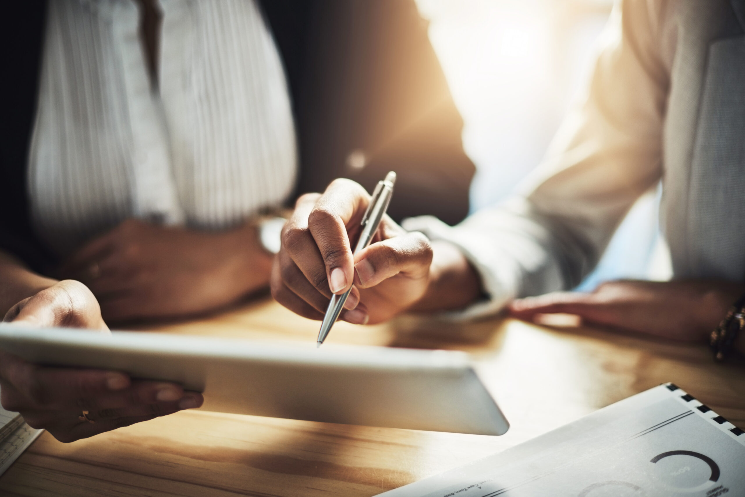 Hands sign and people with tablet office and approval for home loan and process with digital form Client signature and real estate agent with tech for mortgage writing and agreement in meeting